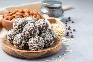 Healthy homemade paleo chocolate energy balls with rolled oats, nuts, dates and chia seeds, horizontal, copy space