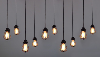 Beautiful hanging light bulbs on plain background for card, banner, wallpaper