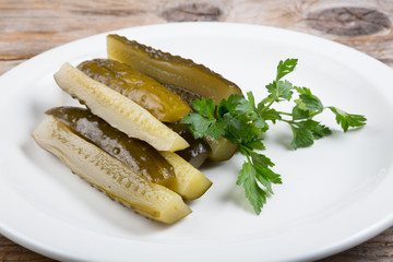 Canned cucumbers on a white plate