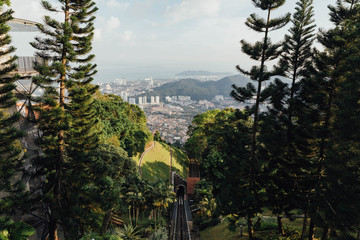 Sunny cityscape and mountain with green that viewed from Penang Hill at George Town. Penang, Malaysia.