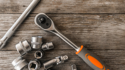 Spanner head and power wrench on a wooden table in the workshop