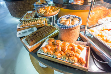 Assortment of fresh pastry on table in buffet .