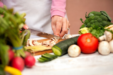 Woman cutting champignons