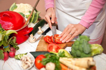 Woman cutting tomato