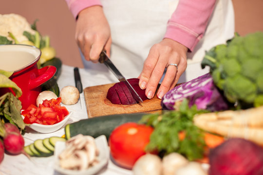 Woman Cutting Beetroot With A Knife