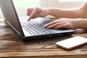 Woman working at home office hand on keyboard close up