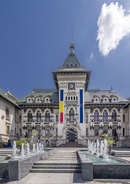Jets of water from the fountain near the facade of the Administrative Palace of Craiova (today Dolj Prefecture and County Council), Romania, on a sunny day