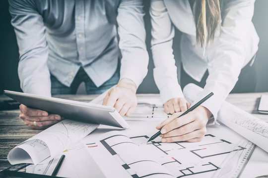 Designers discuss the sketches inside the house.