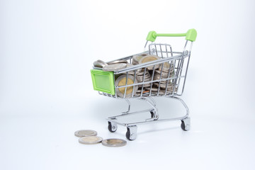 Isolated picture : Mini supermarket cart with coins.