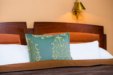 Detail of turquoise pillow on the bed