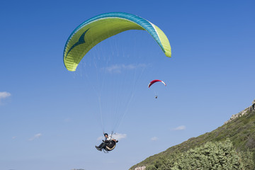 Paragliding in blue cloudy sky