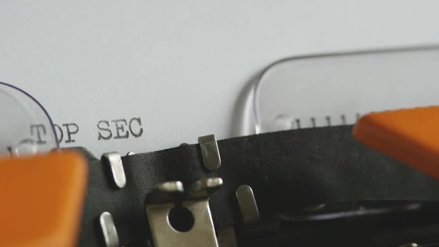 Close up footage of a person writing TOP SECRET on an old typewriter, with sound...