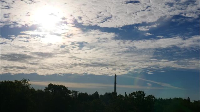 Sunset Time Lapse Sky and moving clouds Power Plant pipe with smoke Latvia 4K