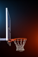Basketball hoop isolated on black. Lightened by mixed color lights.