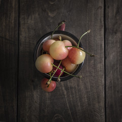 Naklejka na ściany i meble Freshly picked cherries on dark wooden table
