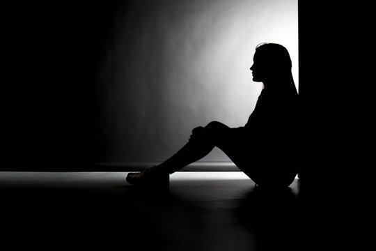 Silhouette einer sitzenden jungen Frau