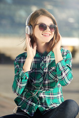 Young girl listening to music outdoors