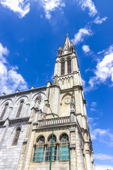 Fototapeta na wymiar Sanctuary of Our Lady of Lourdes against the sky. France