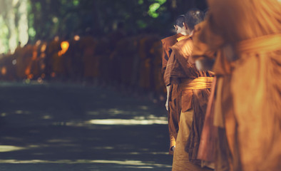 Buddhist Monks Line up in Row Waiting for Buddhism People to Give Alms Bowl in Thai Temple.