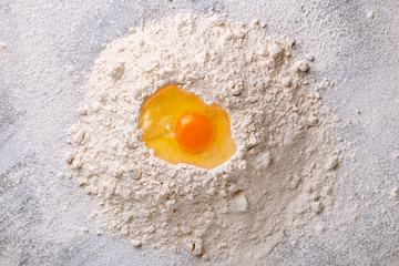 Pasta ingredients. Flour and eggs viewed from above on a marble table. Preparing pasta dough. Top view