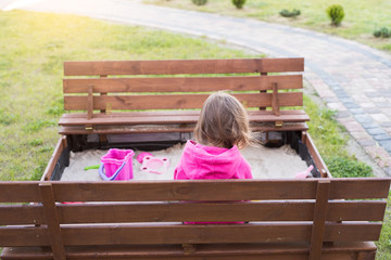 The child is playing in the sandbox
