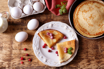 Tasty pancakes with berries on plate