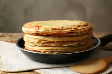 Frying pan with tasty pancakes on table, closeup