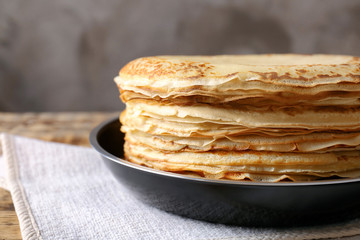 Frying pan with tasty pancakes on table, closeup