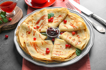 Tasty pancakes with jam on plate