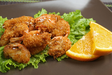 Plate with delicious coconut shrimps, closeup
