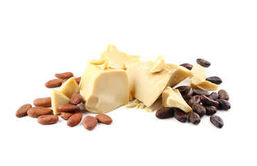 Pieces of cocoa butter and beans on white background