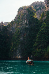 Beautiful mountains at the Phi Phi islands. Touristic boats in the sea in Thailand