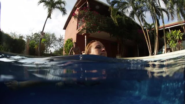 Underwater shoot of the young couple swimming in the pool
