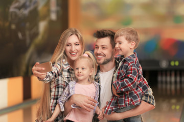 Fototapeta premium Family taking selfie at bowling club