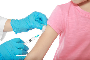 Obraz premium Vaccination concept. Female doctor vaccinating cute little girl on white background, closeup