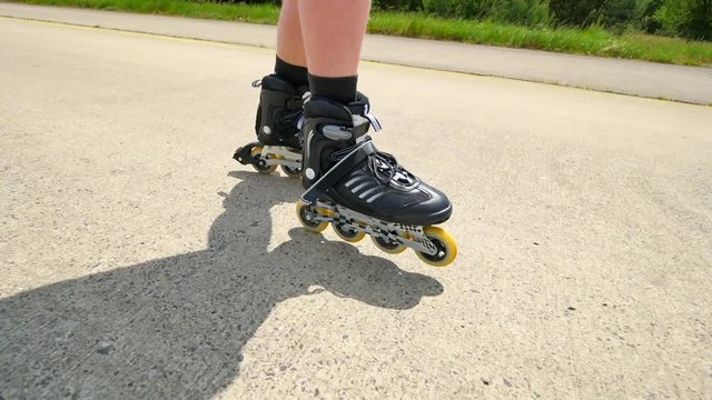 Roller skating and heel braking on the asphalt. Close up view to quick movement and slow down.