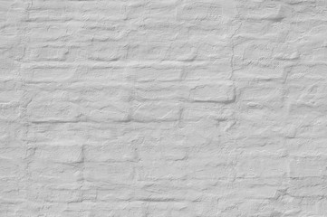 Whitewash  painted old brick wall  with plaster texture. Background  for text or image. 