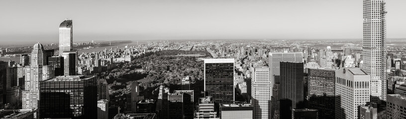 Black & White aerial panoramic view of Central Park with Midtown skyscrapers, Upper West and Upper East Side buildings. Manhattan, New York City