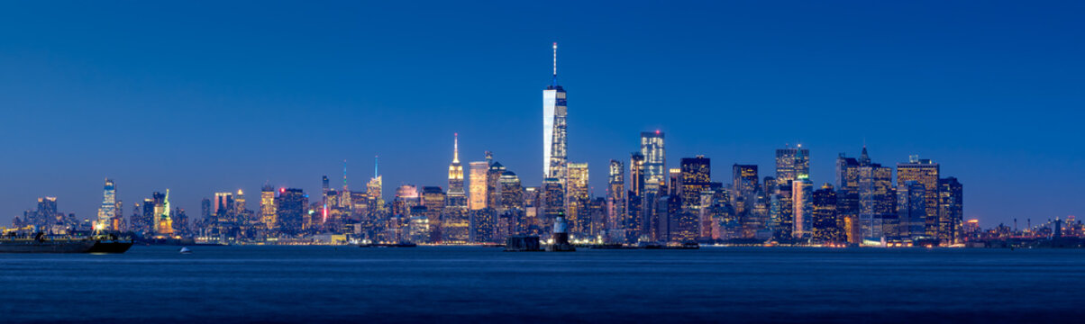 Panoramic view of Lower Manhattan and New York City Harbor with Financial District skyscrapers at twilight