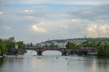 PRAGUE, CZECH REPUBLIC - 12 MAY 2017: View of the Vltava River with the pleasure boat and the Legia Bridge (Most Legii)