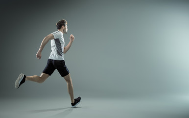 Fototapeta na wymiar Running, young male athlete - isolated