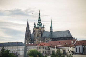 Fototapeta premium Colorful Prague gothic Castle above the River Vltava with Charles Bridge after Sunset, Czech Republic