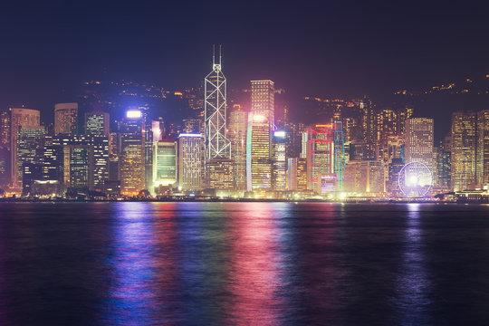 Cityscape and skyline at Victoria Harbour in Hong Kong city at night time.