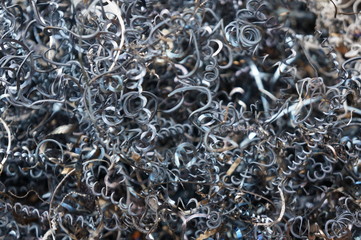 Steel shavings of black metal with rusty elements