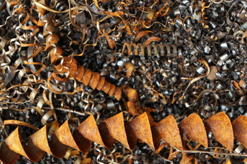 Steel shavings of black metal with rusty elements