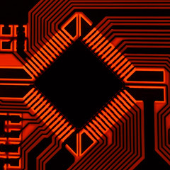 The silhouette of the electrical board with a microprocessor is illuminated by red light.