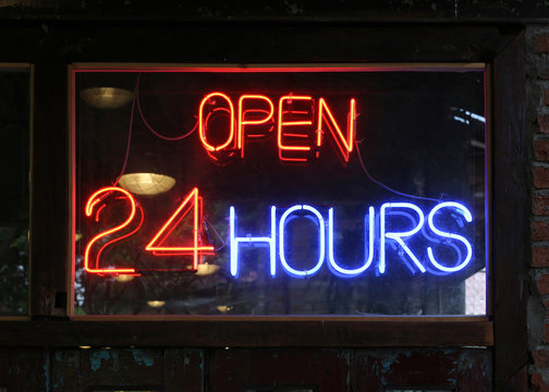 Open 24 Hours neon sign on a restaurant.