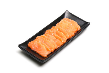 salmon slices in black plate on white background