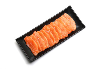 salmon slices in black plate on white background