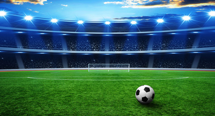 Naklejka premium Soccer ball on green stadium